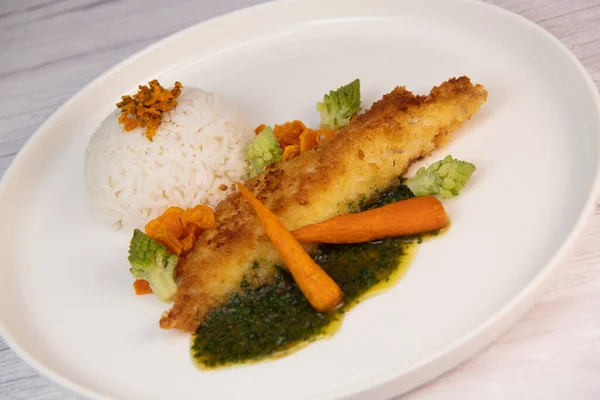 stock image Recipe for Hake fillet breaded with panko, rice, carrot chips and coriander sauce. High quality photo