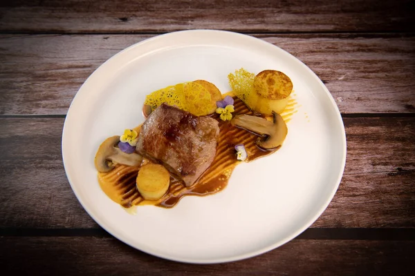 Recipe for veal, potato confit, mushroom, carrot puree, balsamic vinegar sauce, honey and veal stock. High quality photo