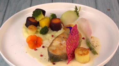 Recipe of cod steak, mashed potatoes and its farandole of vegetables, parsnip, turnip, broccoli, candied potato. High quality video