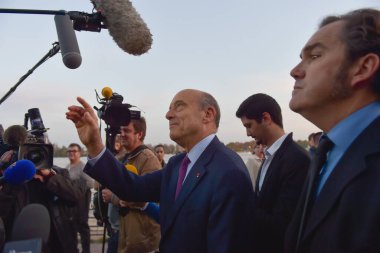 BORDEAUX, FRANCE - 22 NOVEMBER 2014 : Alain Juppe, mayor of the city of Bordeaux walking on the quays of the Garonne. High quality photo