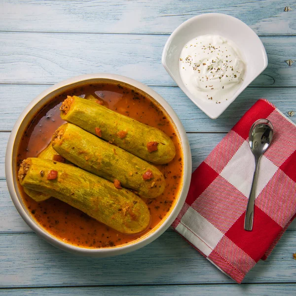 stock image Recipe of stuffed courgette with tomato sauce, Lebanese style, Kouca Mehchi bi Banadoura, with Greek yogurt. High quality photo