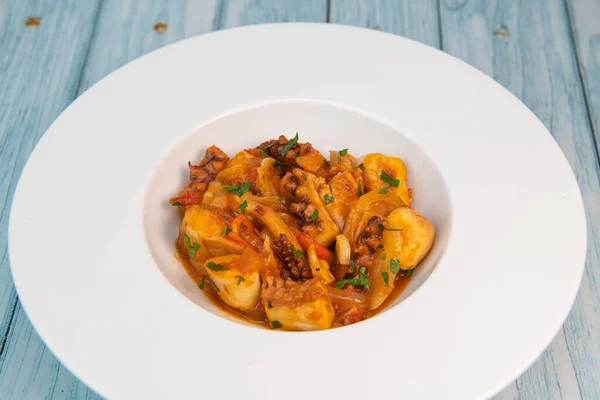 stock image Recipe for octopus Provencal style, tomato, onion, garlic, red pepper, parsley, High quality photo