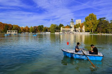 MADRID, SPAIN - NOVEMBER 18, 2023, Artifical lake and monument to Alfonso XII in the Buen Retiro Park, one of the main attractions of Madrid, Spain. High quality photo clipart