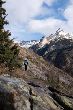 Hiker walking on the path in Pyrenees mountains near Gavarnie, High quality photo clipart