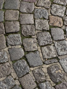 Soyut arkaplan. Eski parke taşı yakın plan, üst manzara. Asfalt döşeme dokusu. Antik taş kaldırım düz olmayan ışık, yüksek kalite fotoğraf