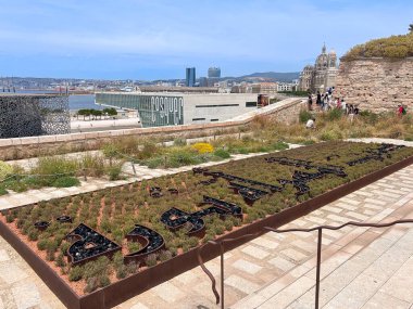 MARSEILLE, FRANCE - June 07, 2024: Exterior view under the Memorial of the Deportations with arabic sign in garden, High quality photo clipart