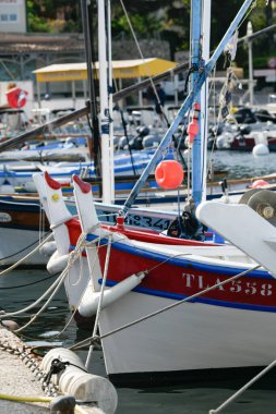 France, Porquerolles - June 09, 2024: Colourful traditional wooden fishing boats in the port reserved for professional fishermen on the island of Porquerolles. High quality photo clipart