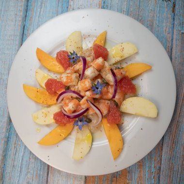 RECIPE CEVICHE OF SHRIMPS AND SCALLOPS WITH CITRUS FRUIT, LEMON, LIME, SQUEEZED ORANGE, GRAPEFRUIT AND FRUIT, PERSIMMON, APPLE, SEASONED WITH ESPELETTE PEPPER. High quality photo clipart