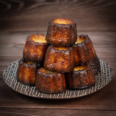 Caneles de bordeaux, traditional French sweet dessert with white table background, High quality photo clipart