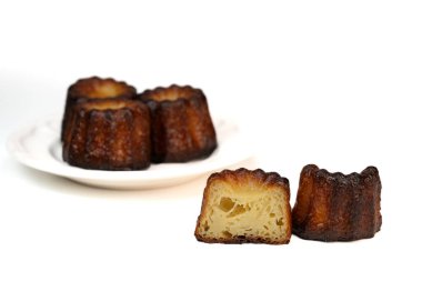 Caneles de bordeaux, traditional French sweet dessert with white table background, High quality photo clipart