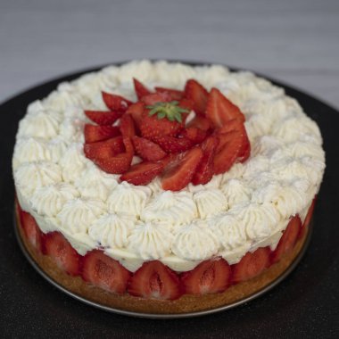 Bu daha Fraisier kek tabakaları taze çilek katmanları ve şantilya krem altın sünger tabanında, tatlı meraklıları için güzel sunulan özel bir toplantı sırasında.