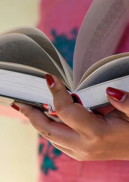 stock image Close up on woman hands turning page in vintage book. Woman read a book. Selective focus, book close-up. Vertical images.