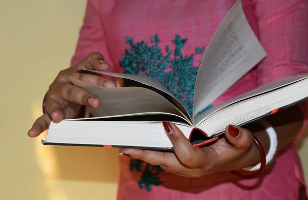 Close up on woman hands turning page in vintage book. Woman read a book. Selective focus, book close-up.