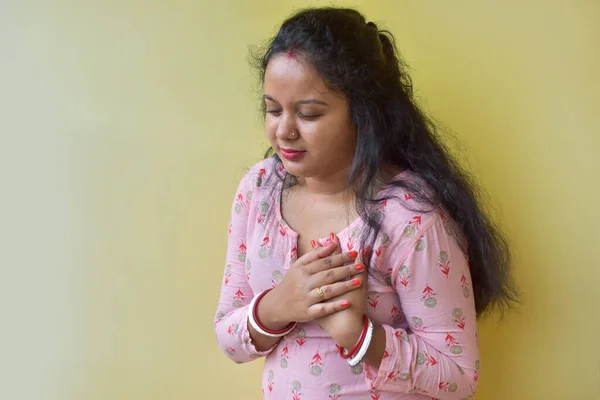 Indian women with pain at the heart. Young women with heart disease. Women have symptoms of heart attack, congestive heart failure. Selective focus.