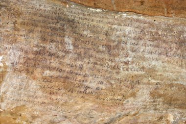 Bhuwaneswar,Odisha,India-March10,2023: Early 2nd century BC Indian epigraphy or cave script by king kharavela at Udayagiri hills in Bhubaneswar, Odisha, India clipart