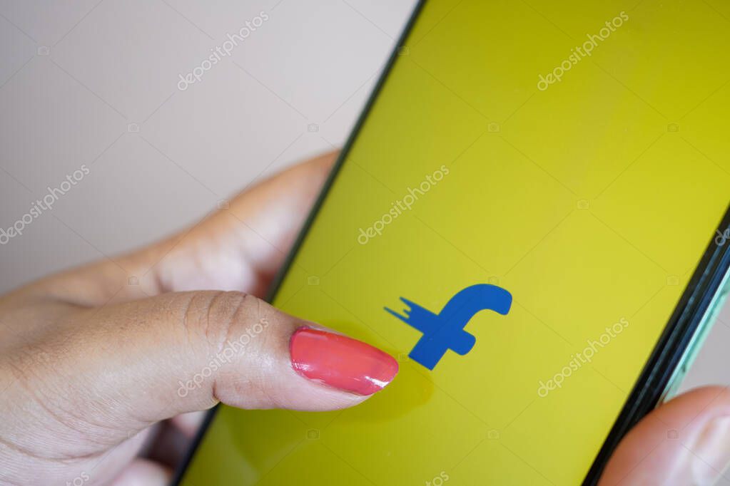 West Bengal, India - May 16 , 2025; A woman holding a smartphone and the Flipkart app logo on the phone screen. Online shopping on mobile app concept. Flipkart is the largest online retailer in India