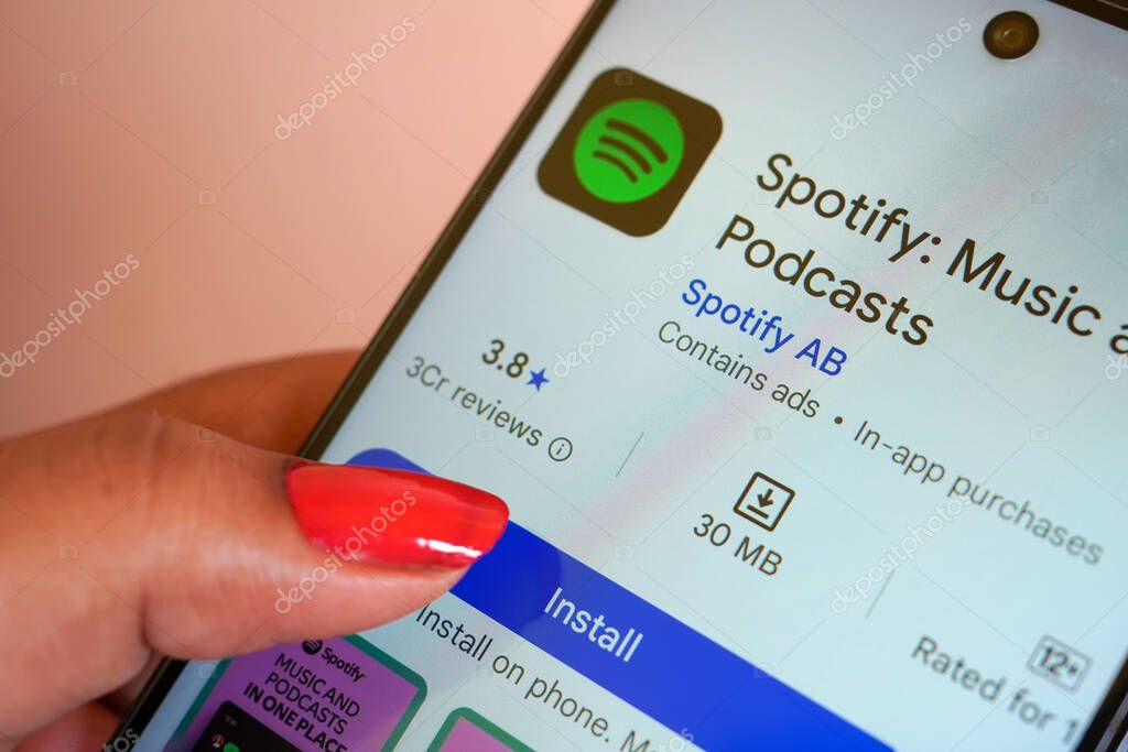 West Bengal , India - May 16 , 2025: Woman holds smart phone with Spotify app on the screen. Spotify is a Swedish audio streaming service founded on 23 April 2006 by Daniel Ek and Martin Lorentzon.