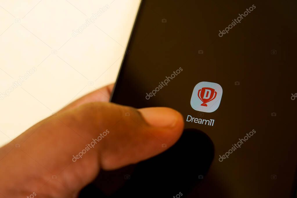 West Bengal, India - May 16 , 2025: Person holding smartphone with logo of Sporta Technologies Private Limited (Dream11) on screen in front of website. Focus on phone display. Unmodified photo.