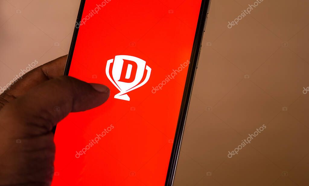 West Bengal, India - May 16 , 2025: Person holding smartphone with logo of Sporta Technologies Private Limited (Dream11) on screen in front of website. Focus on phone display. Unmodified photo.
