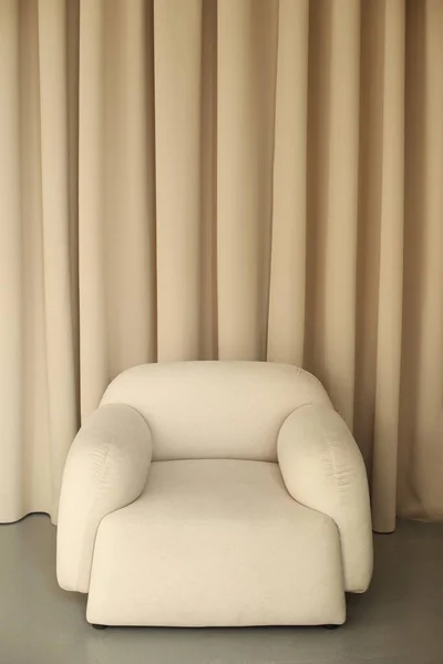 Luxurious beige armchair in cozy interior isolated on background.