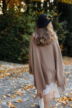 Smiling happy active woman on the path in autumn near the forest