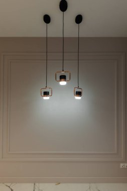 A modern lamp in a gray room. Interior