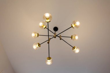 A lamp on the ceiling in a modern room interior