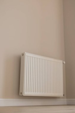 Heating battery on the wall in the interior of a modern apartment