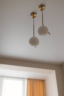 a white round light bulb in a modern interior of a house room