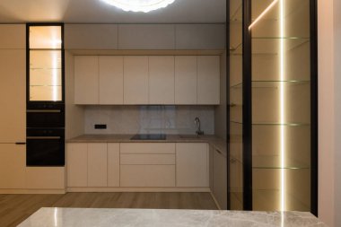 Modern kitchen in the interior of a new apartment in beige tones