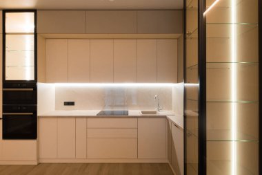 Modern kitchen in the interior of a new apartment in beige tones