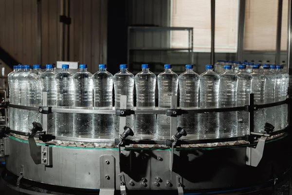 Plastic bottles filled with fresh water on a production line.
