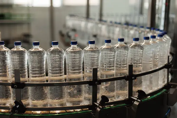 A production line showcasing plastic bottles filled with clean, fresh water.