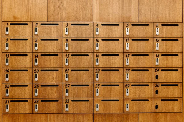 Secure wooden mail cabinets equipped with smart locks using chip and access cards for controlled access.