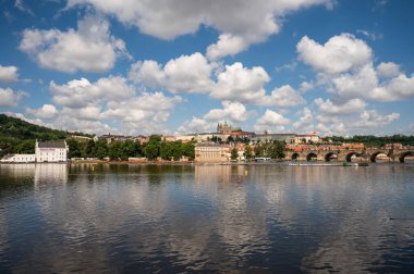 Panoramic view above at Charles Bridge Prague Castle and river Vltava Prague Czech Republic. Picturesque landscape with sunset old town houses with red tegular roofs and broach tower.