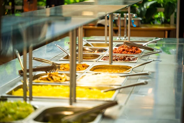 Asian food buffet in restaurant multiple food dishes and salad. Eat as much as you like Indian buffet restaurant. You can buy delicious food at an affordable price. Copyspace.