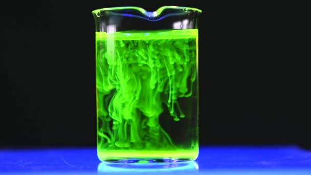 Woman Scientist Experimenting Green Fluorescent Solution Glass Conical Flask Dark — Stock Video