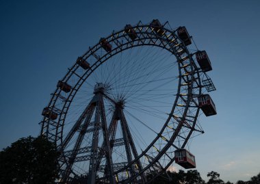 Dev feribot çarkı bir lunaparkta insanlarla hareket ediyor. Eğlence için güneşli bir gün. Kopyalama alanı.