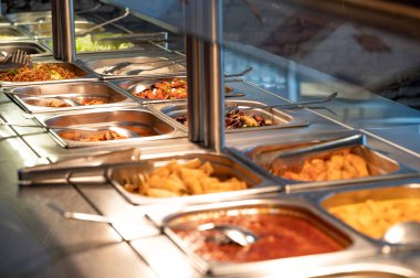 Restoranda Asya yemekleri, birden fazla yemek ve salata. Hint büfesi restoranını sevdiğin kadar ye. Uygun bir fiyata lezzetli yiyecekler alabilirsin. Kopyalama alanı.