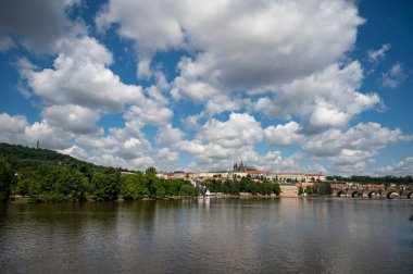 Panoramic view above at Charles Bridge Prague Castle and river Vltava Prague Czech Republic. Picturesque landscape with sunset old town houses with red tegular roofs and broach tower.