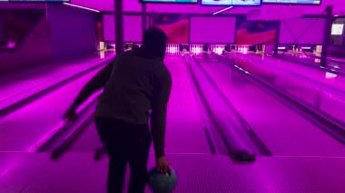 Oyun sahasında kapalı alanda bowling oynayan tutkulu insanlar. Arka plan oyun sahasının 4K videosu. Eğlence hobisi takım oyunu. 