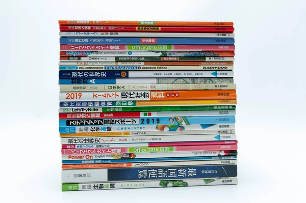Fuji-Shi, Shizuoka-Ken, Japan - August 9, 2022: Stacked Japanese school books. Isolated on white background.