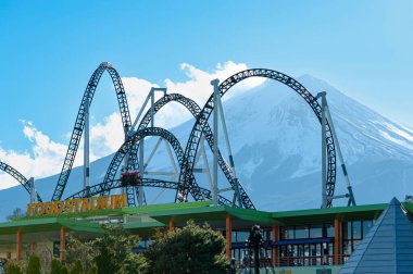 Fuji-Q Highland, Fujiyoshida City, Yamanashi Prefecture, Japan - January 3, 2019: Takabisha World's Steepest Roller Coaster. Background with Mount Fuji and beautiful blue sky.