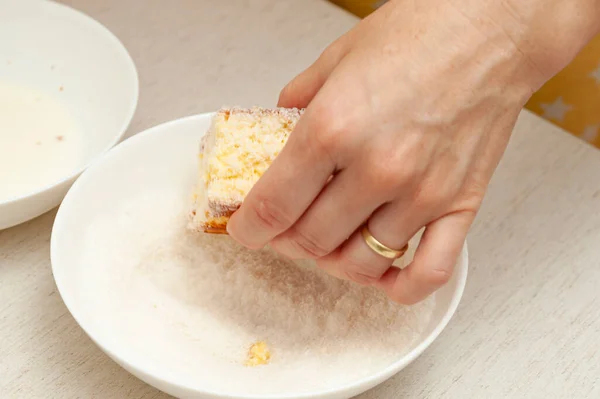 stock image Hand passing in grated coconut traditional Brazilian dessert known as BOLO GELADO.