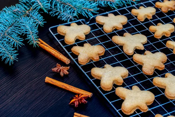 Freshly baked gingerbread man shaped biscuits with Christmas decoration