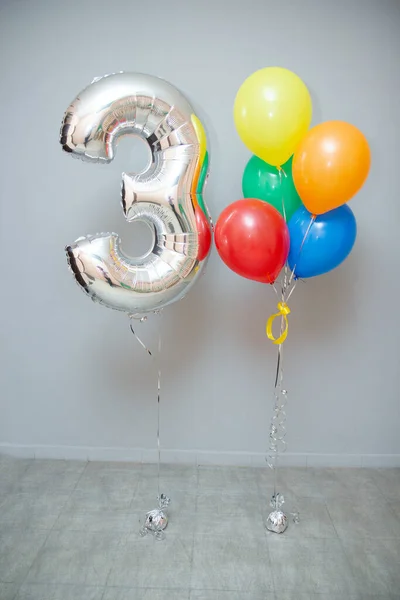 Ένα Μάτσο Πολύχρωμα Μπαλόνια Και Ένα Ασημένιο Νούμερο Στο Φόντο — Φωτογραφία Αρχείου