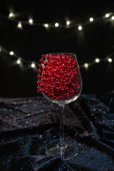 stock image red New Year's decor in a glass, red wine in a glass