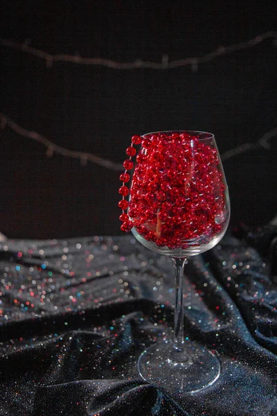 stock image red New Year's decor in a glass, red wine in a glass