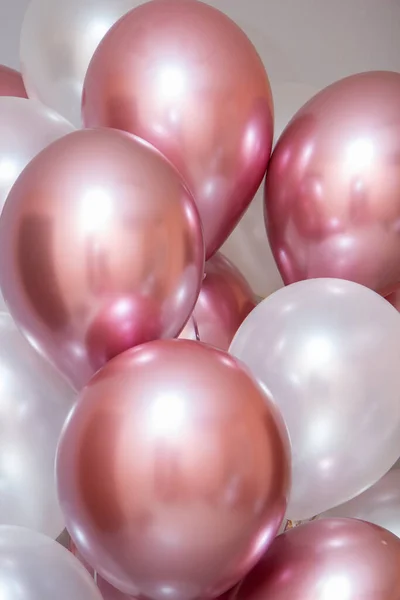 pink and white balloons on wall background
