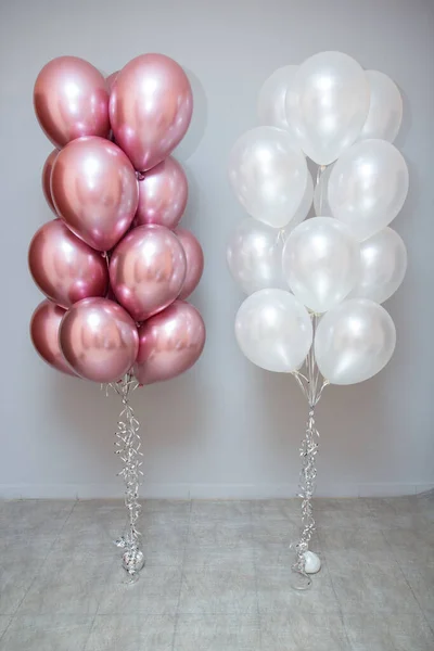 pink and white balloons on wall background